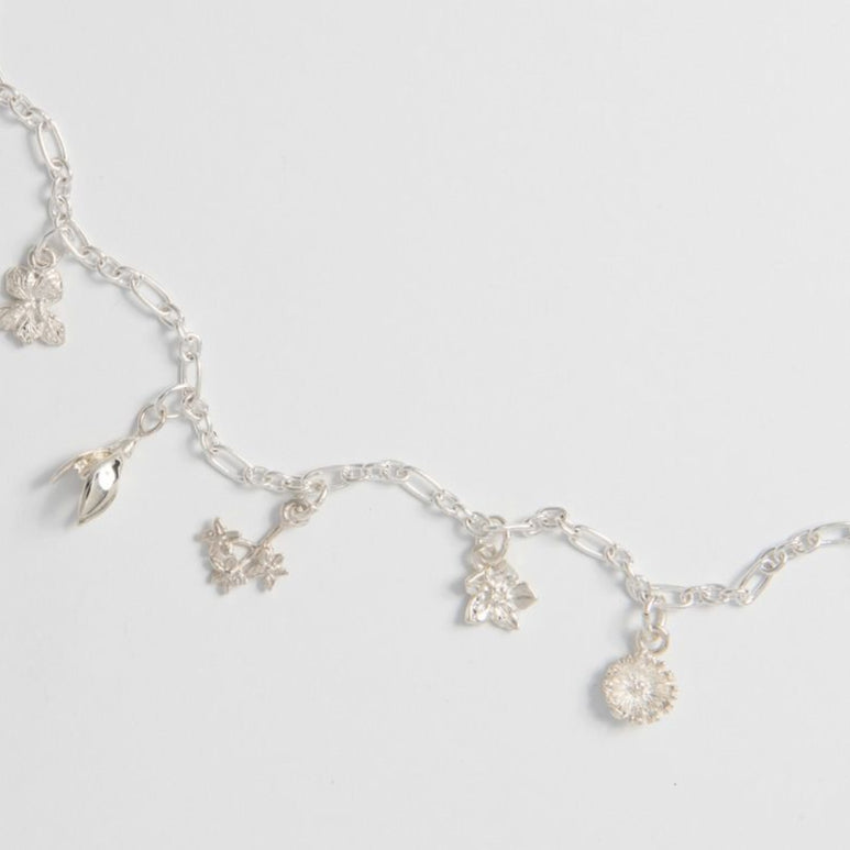Dainty floral charm bracelet inspired by nature.