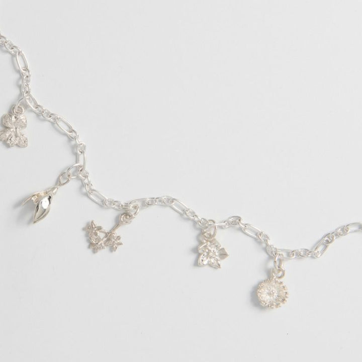 Dainty floral charm bracelet inspired by nature.
