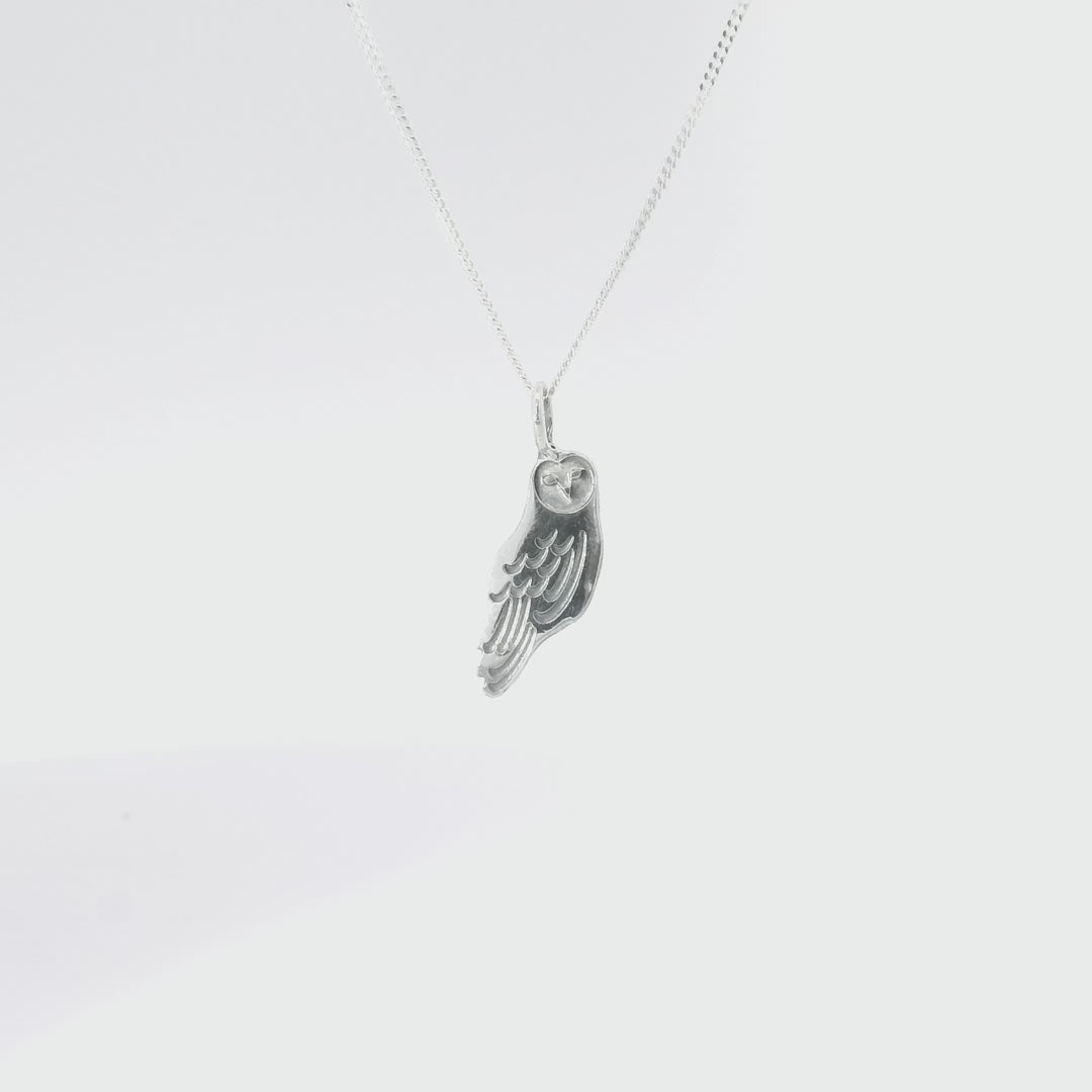 Close-up turnaround of Sterling Silver Barn Owl Pendant Necklace, showcasing intricate feather details and heart-shaped face design.