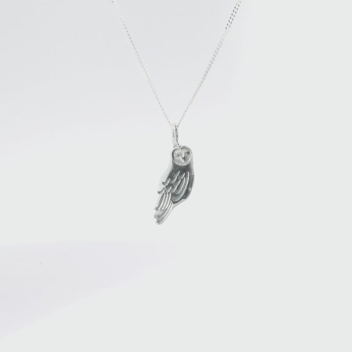 Close-up turnaround of Sterling Silver Barn Owl Pendant Necklace, showcasing intricate feather details and heart-shaped face design.