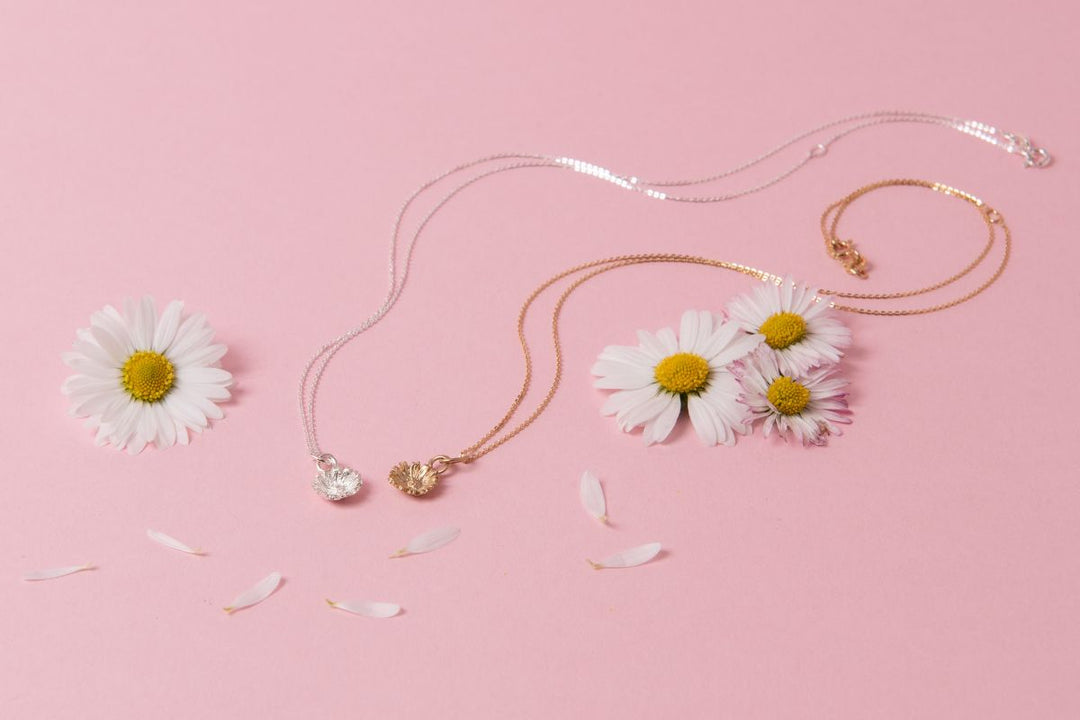 Sterling Silver daisy pendant necklace on pink ribbon, meaningful Mother’s Day jewellery by Blackbird Jewellery