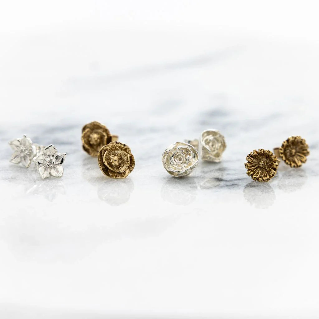 Handmade floral earrings in sterling silver and gold vermeil displayed in a jewellery box from Blackbird Jewellery’s Flowers collection.