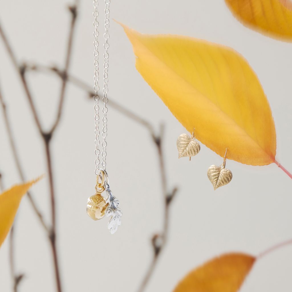 Handmade oak leaf and acorn charm necklaces in sterling silver and gold vermeil from Blackbird Jewellery’s Woodland collection.