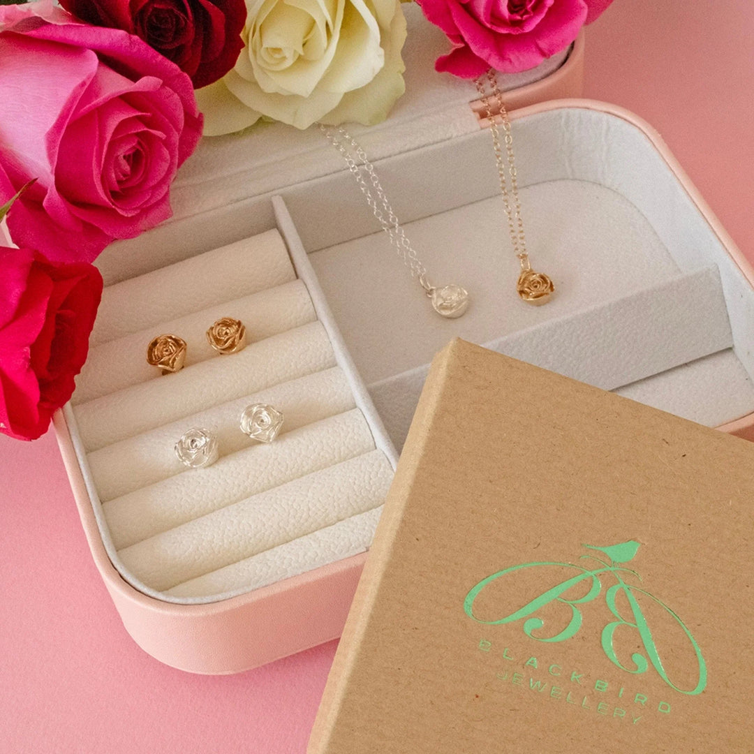 Handmade birthflower necklaces in sterling silver and 18ct gold vermeil displayed on white gift boxes with paper petals.