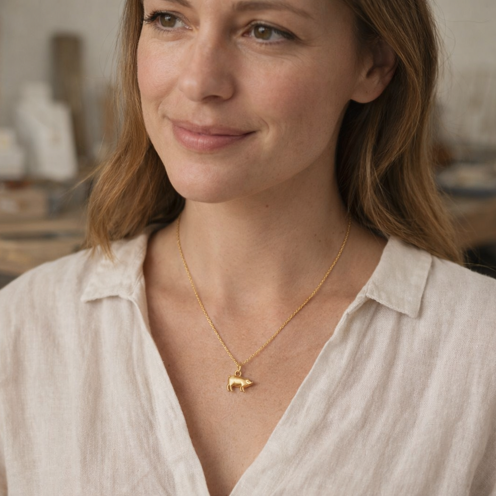 Blackbird Jewellery 18ct gold vermeil lucky pig charm necklace with fine chain, handcrafted three-dimensional pig pendant symbolising prosperity and good fortune model wearing