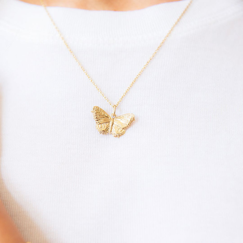 18ct gold vermeil butterfly necklace with detailed wings, front view worn on model