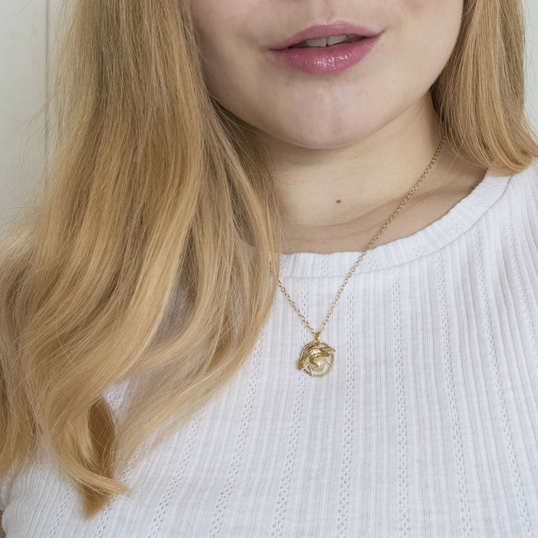 Blackbird Jewellery Model wearing gold queen bee necklace layered with other necklaces.