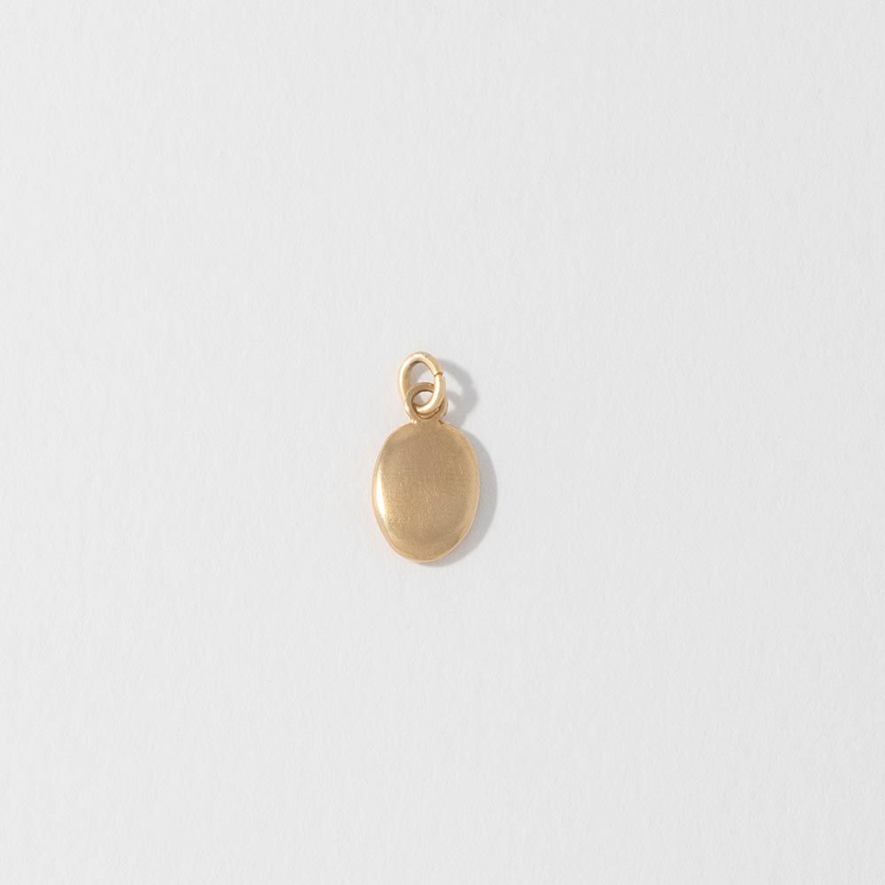 Blackbird Jewellery Small 18ct gold vermeil pebble charm cast from a real beach pebble, front view.