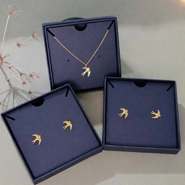Blackbird Jewellery swallow necklace and swallow stud earrings in 18ct gold vermeil displayed in gift boxes