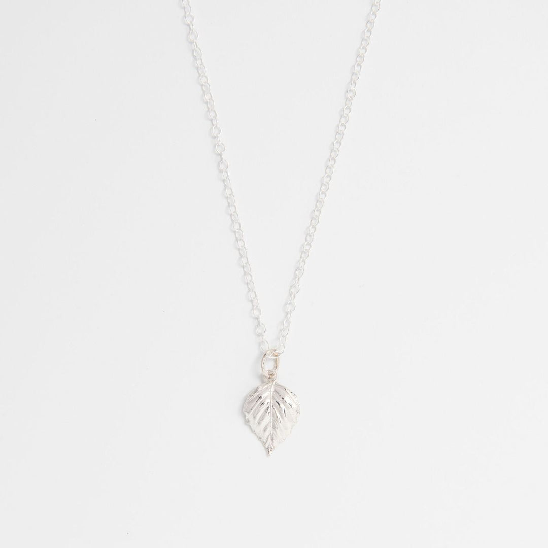 Sterling silver birch leaf necklace on white background – handmade nature-inspired jewellery by Blackbird Jewellery