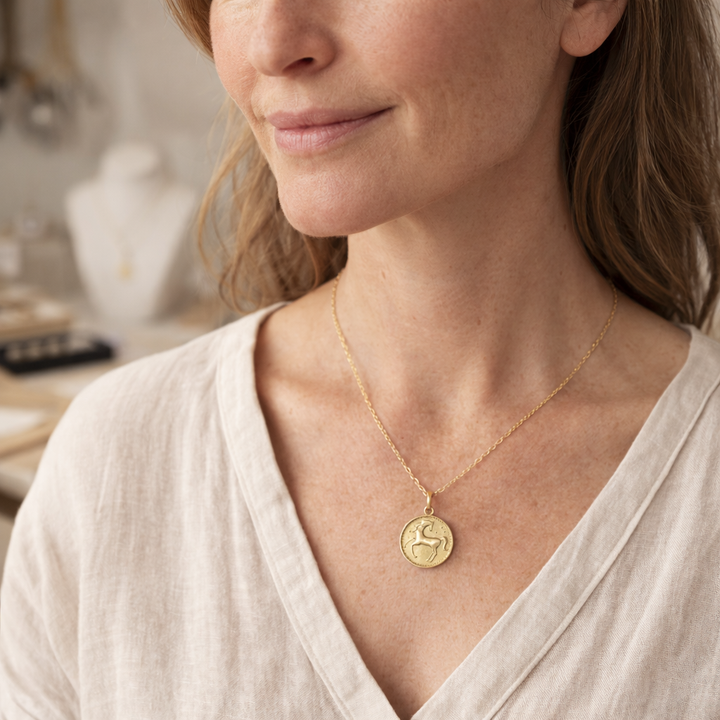 Model wearing 18ct gold vermeil horse necklace by Blackbird Jewellery