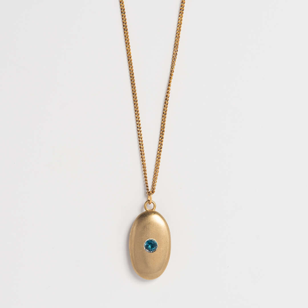 Gold vermeil pebble necklace with blue topaz gemstone – handmade sea-inspired jewellery by Blackbird Jewellery