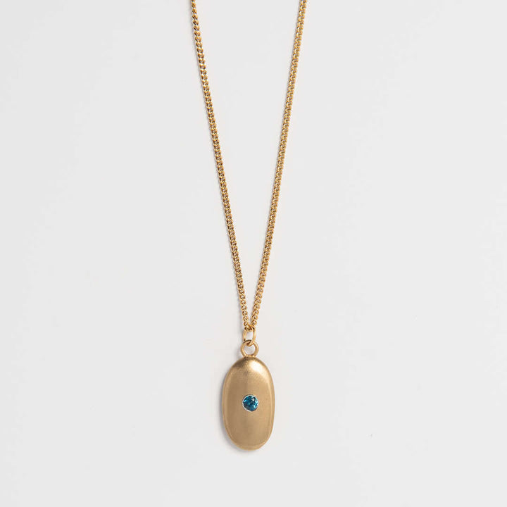 Gold vermeil pebble necklace with blue topaz gemstone – handmade sea-inspired jewellery by Blackbird Jewellery