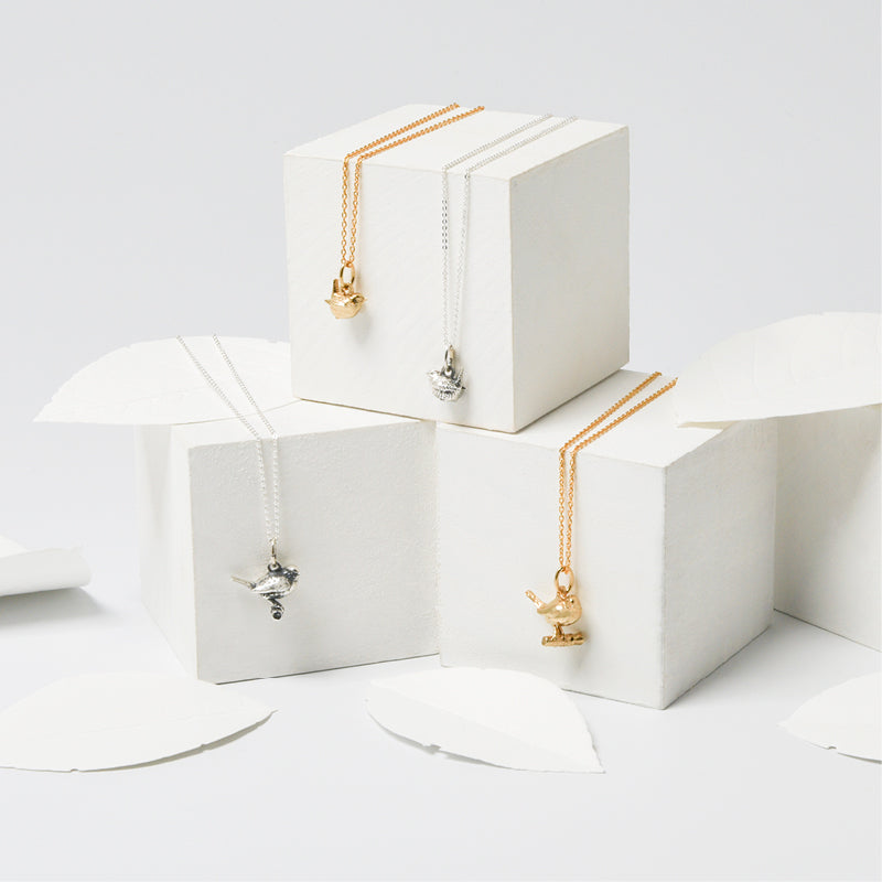 Blackbird Jewellery Delicate silver and gold bird necklaces on gift boxes — handmade nature-inspired jewellery perfect for gifting.