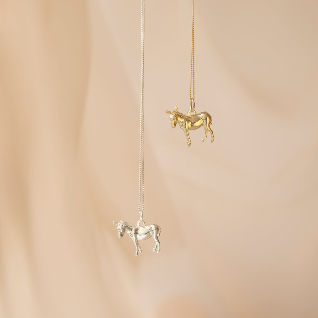 Blackbird Jewellery 18ct Gold Vermeil and Sterling silver donkey pendant necklaces on a beige background