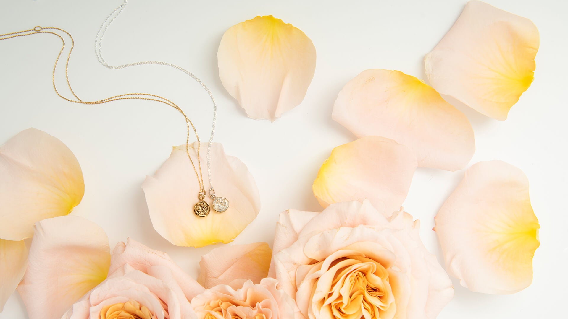 Rose-inspired jewellery displayed on soft petals – celebrating June’s birth flower with handcrafted charm
