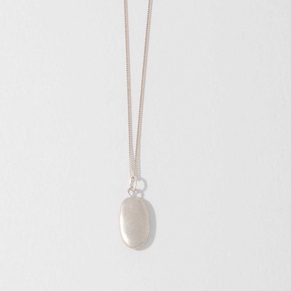A sterling silver pebble charm necklace with a sateen finish on a white background.