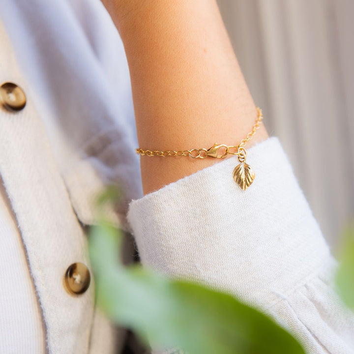 Model wearing of 18ct gold vermeil birch leaf charm on bracelet – Blackbird Jewellery woodland design