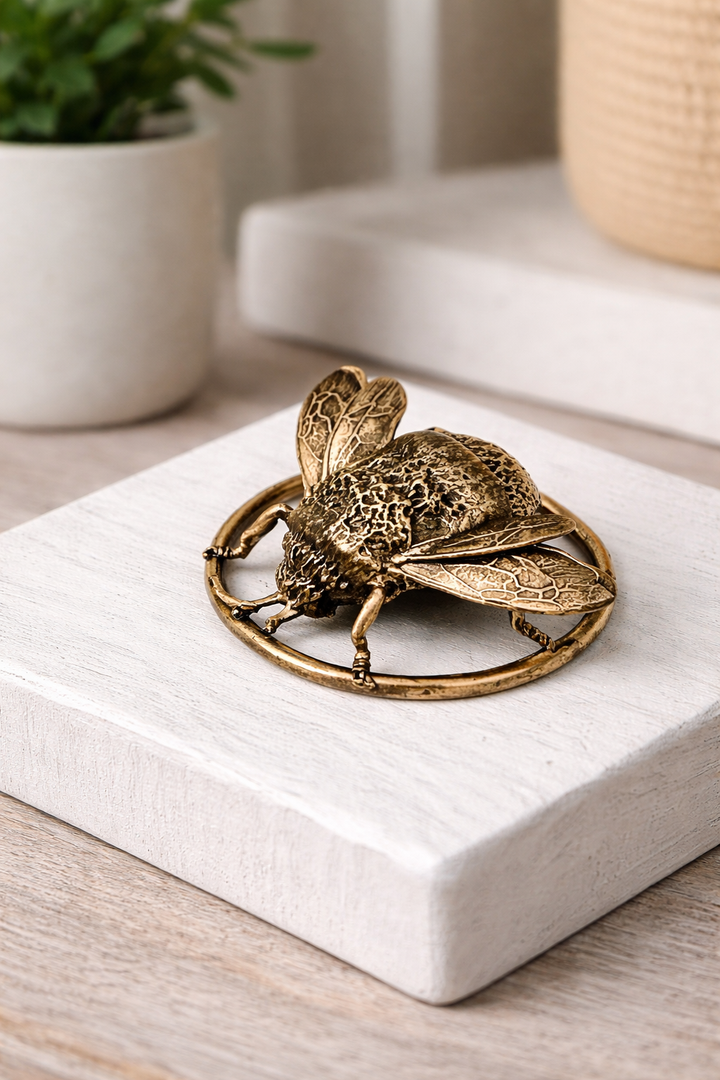 Blackbird Jewellery bumble bee miniature bronze sculpture, handcrafted nature collectable with detailed wings on a decorative bronze ring displayed on a table