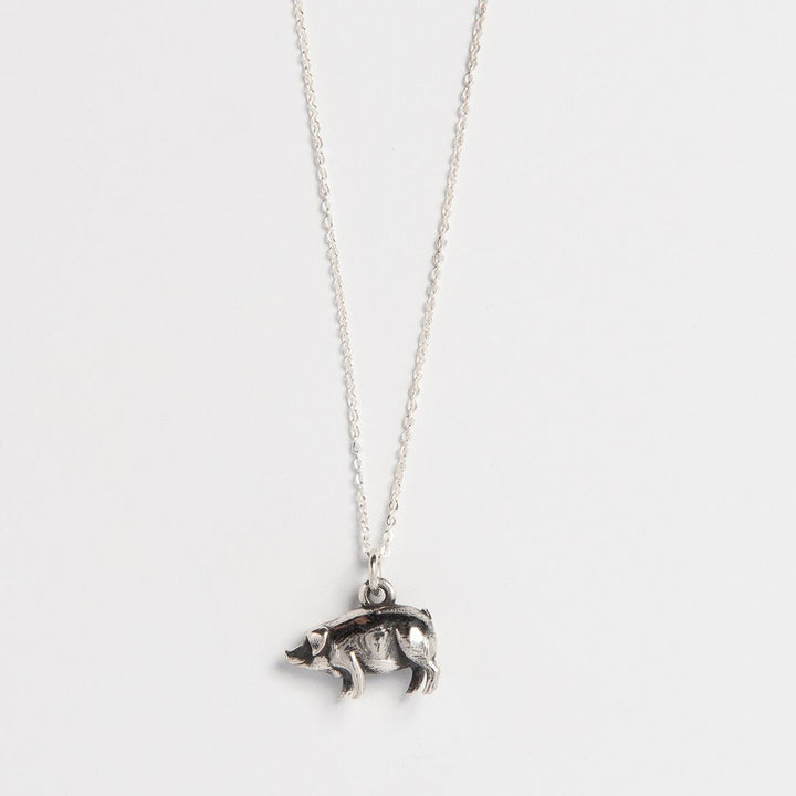 Blackbird Jewellery a sterling silver necklace featuring a three-dimensional pig charm attached to a fine sterling silver chain, displayed against a white background.