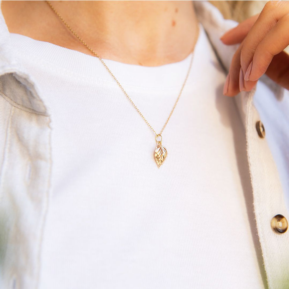 The 18ct Gold Vermeil Birch Leaf Necklace worn on a model, highlighting its elegant and nature-inspired design.