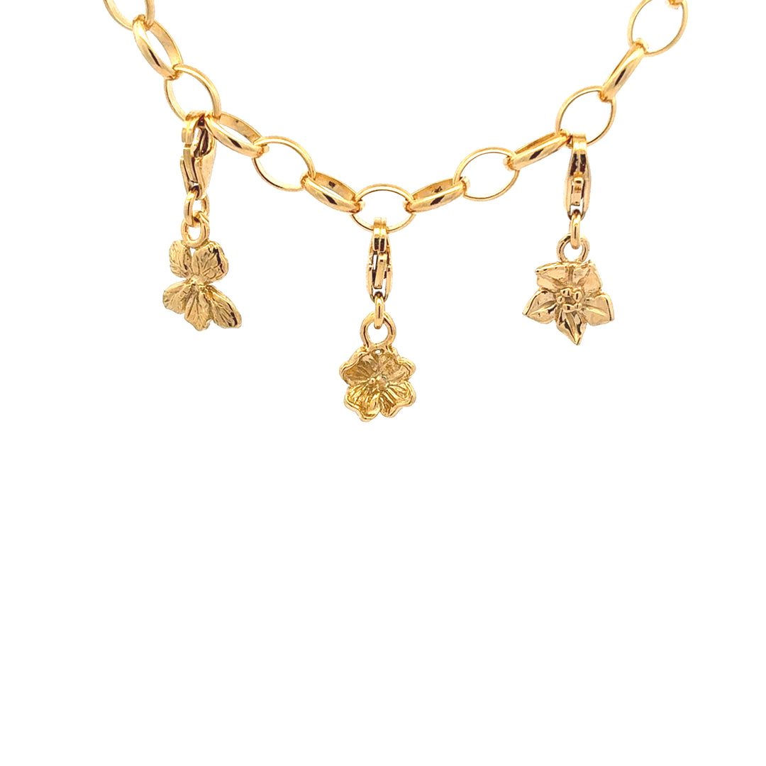 Blackbird Jewellery 18ct gold vermeil floral clip-on charms attached to a paperclip bracelet, handmade nature-inspired jewellery