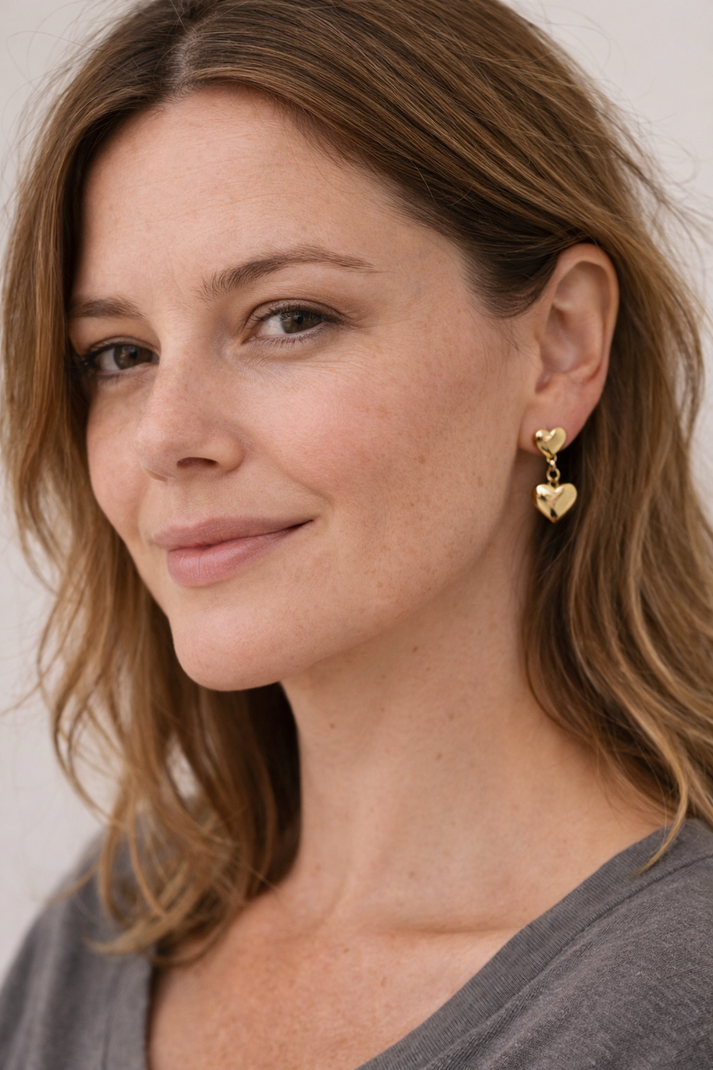 18ct gold vermeil heart drop earrings worn in the ear, handmade jewellery by Blackbird Jewellery
