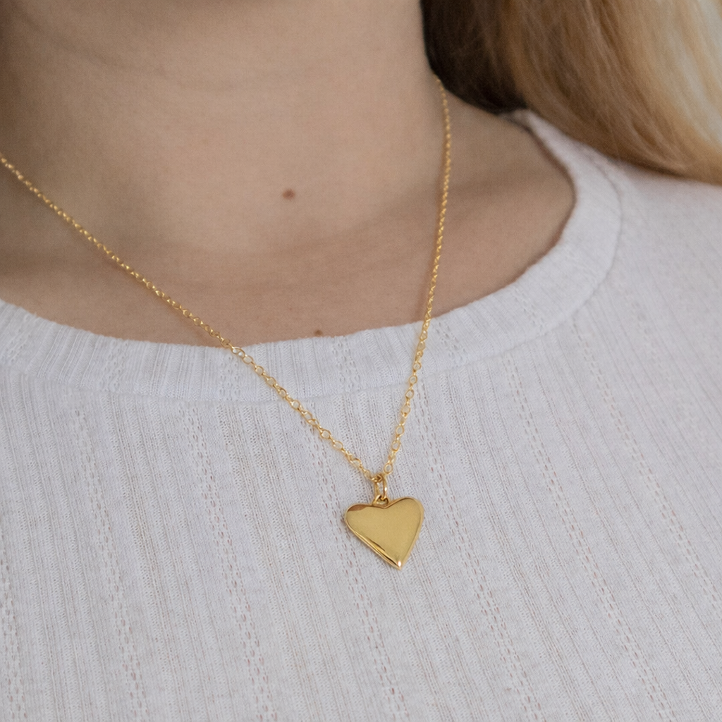 Model wearing Blackbird Jewellery 18ct gold vermeil small heart necklace