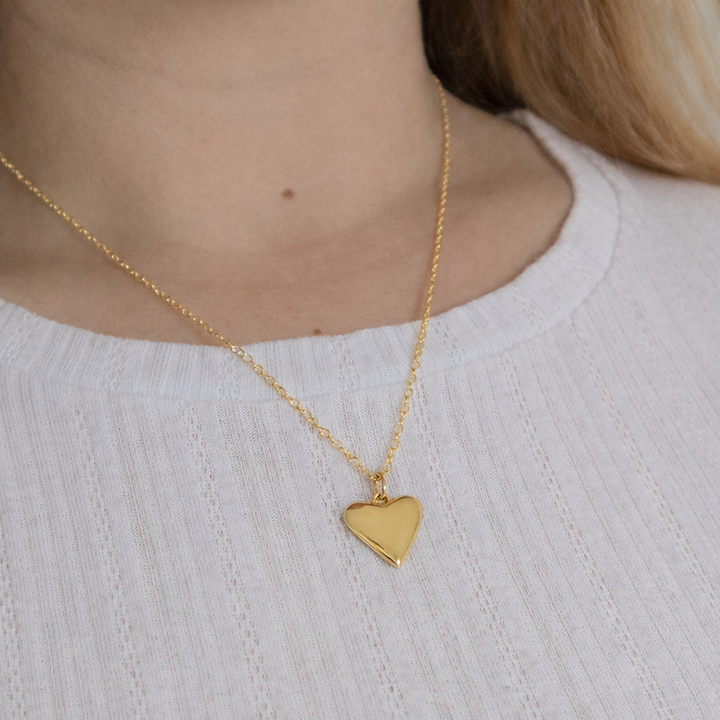 Model wearing Blackbird Jewellery 18ct gold vermeil small heart necklace