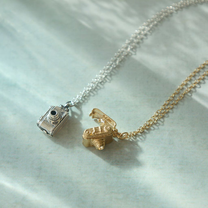 18ct gold vermeil vintage camera necklace styled on fabric, handmade jewellery by Blackbird Jewellery