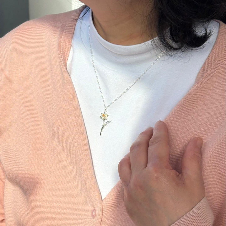 Blackbird Jewellery sterling silver and gold daffodil stem necklace worn by model.
