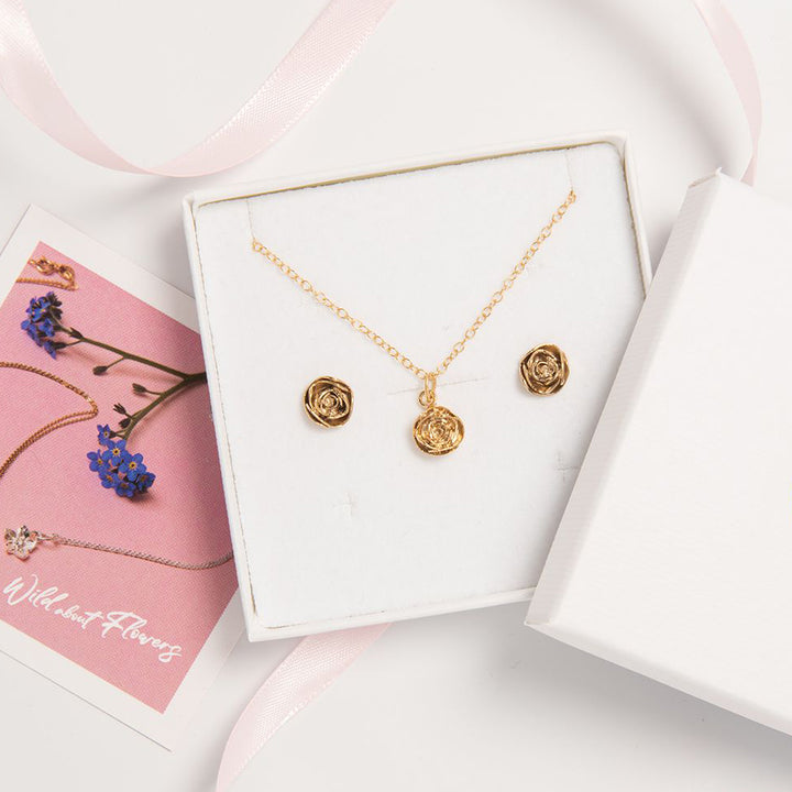 Blackbird Jewellery A gold vermeil rose flower jewellery set, including a necklace and earrings, presented in a white box with a pink ribbon.