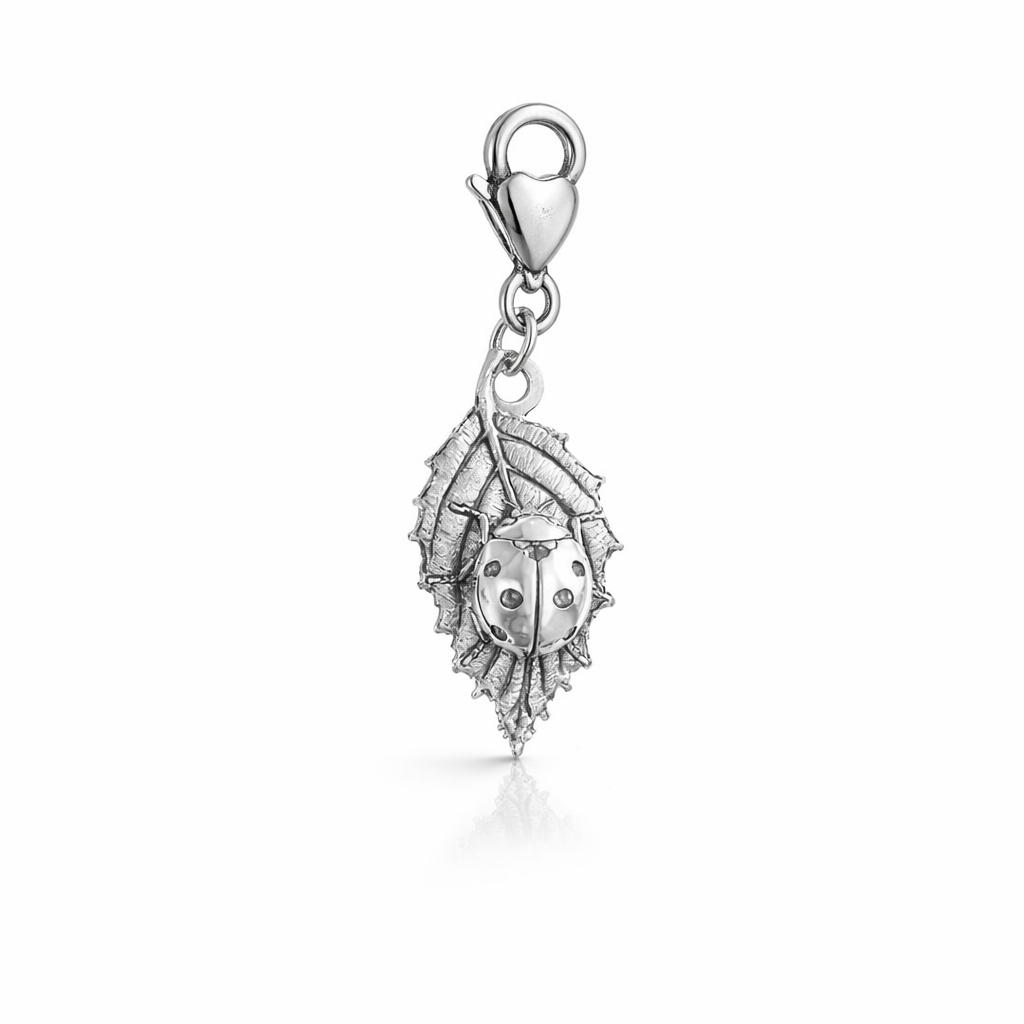 Blackbird Jewellery sterling silver ladybird on leaf clip-on charm with lobster clasp on a soft neutral background