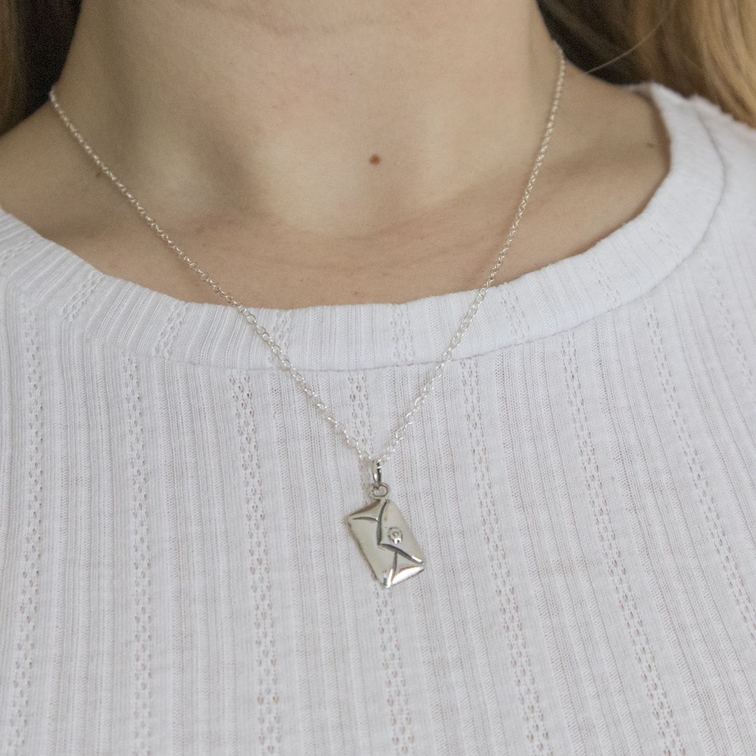 Sterling silver love letter necklace worn on the neckline, romantic handmade jewellery by Blackbird Jewellery