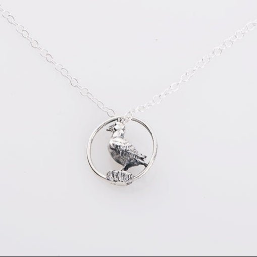 Blackbird Jewellery Sterling silver puffin pendant in a hoop necklace on a white background, with a chain link.