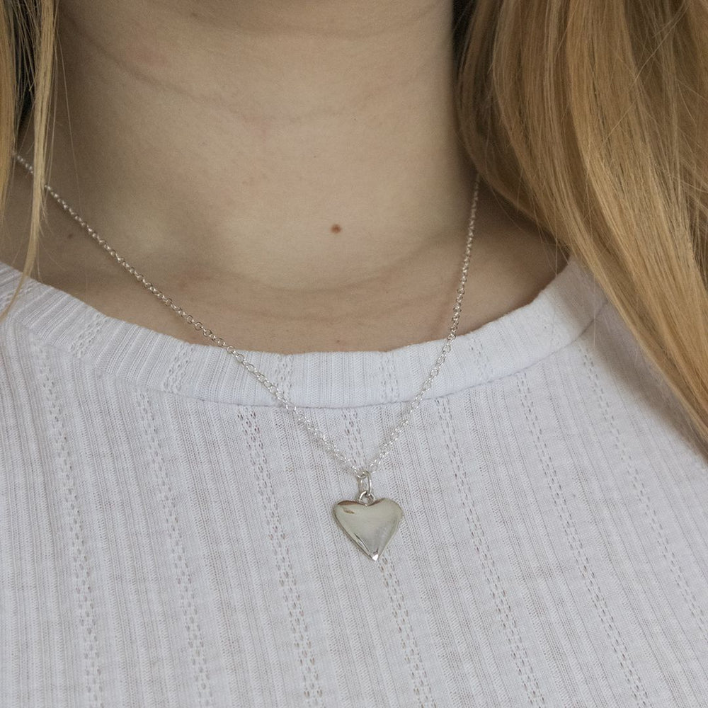 Blackbird Jewellery sterling silver small heart necklace worn layered on model, delicate everyday heart jewellery gift for her