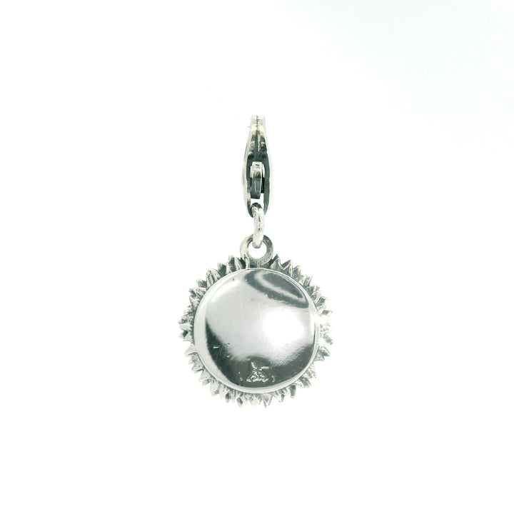 Showing the back of the handmade blackbird jewellery sterling silver sunflower charm next to sunflower necklace – gift for all occasions