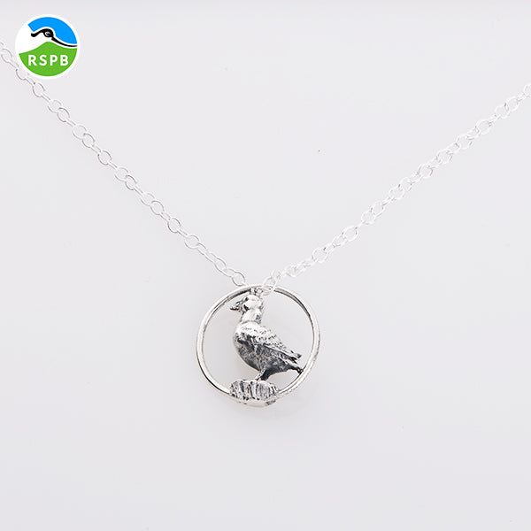 Blackbird Jewellery Sterling silver puffin pendant in a hoop necklace on a white background, with a chain link.