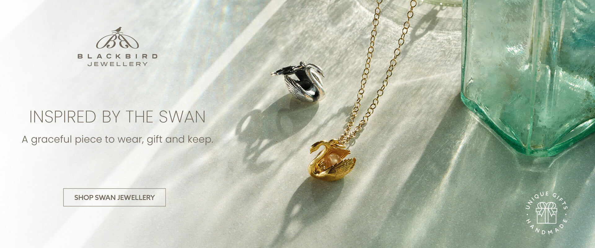 Blackbird Jewellery swan jewellery banner featuring sterling silver and gold swan necklaces with the text Inspired by the Swan