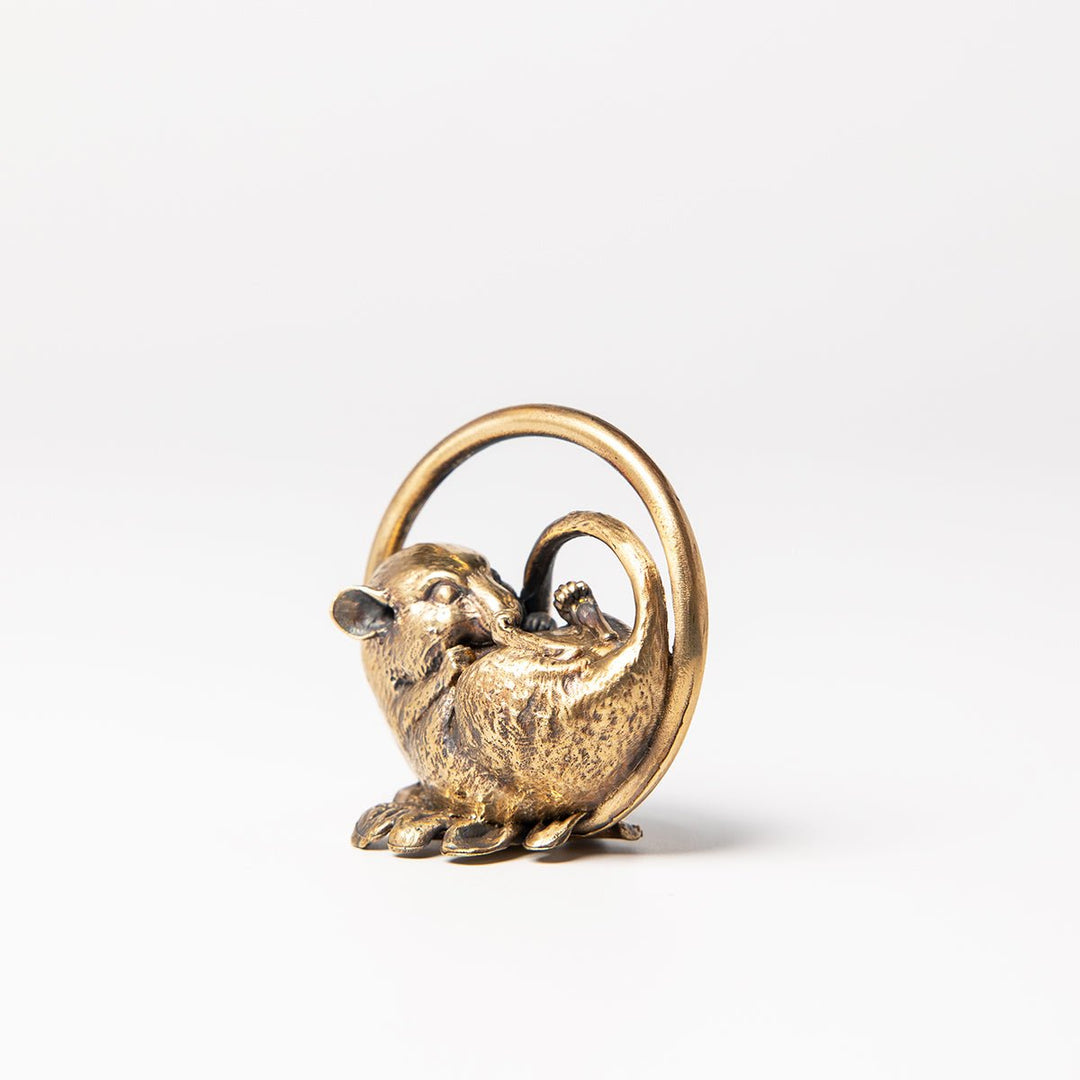 Angled view of a sleeping dormouse bronze ornament highlighting its intricate animal detailing.