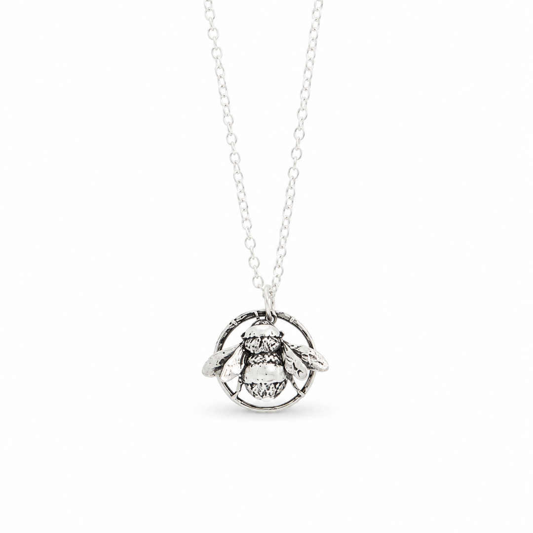 Sterling silver bee necklace  featuring a detailed bee pendant in a circular frame on a delicate chain