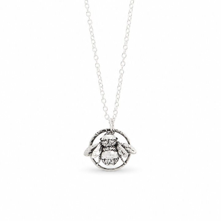 Sterling silver bee necklace  featuring a detailed bee pendant in a circular frame on a delicate chain